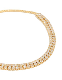 Showcasing a gold plated thin double cubic zirconia tennis toggle bracelet close up view - link has visual effect only