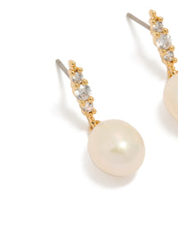 Elegant statement gold plated cubic zirconia and freshwater pearl drop earrings close up view - link has visual effect only