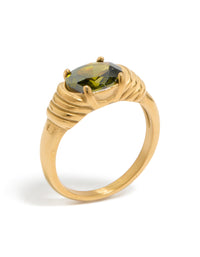 Designed with oval cut green cubic zirconia, this waterproof ring in dainty gold plated stainless steel featuring crystal accents front view - link has visual effect only