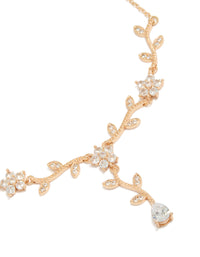 Showcasing a statement necklace with floral vine design featuring leaf accents and cubic zirconia in gold close up view - link has visual effect only