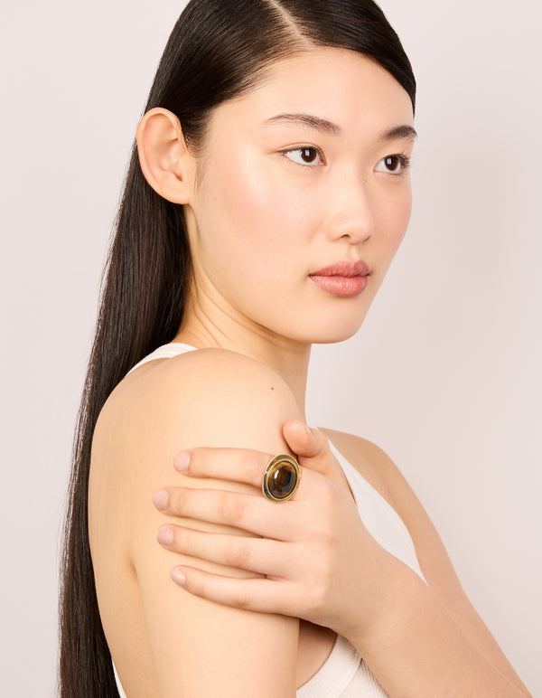 Designed with gold plated chunky brown stone and black enamel in a statement ring on model view