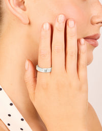 Featuring waterproof cubic zirconia stainless steel spinner ring in silver with clear accents on finger view - link has visual effect only