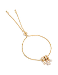 Showcasing a gold plated bracelet with cubic zirconia flower and pearl rondell charm accents in a toggle design front view - link has visual effect only