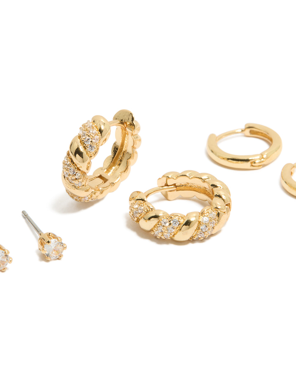 Crafted from gold plated materials featuring cubic zirconia twist mini huggie and stud earrings 3-pack with crystal embellishments close up view