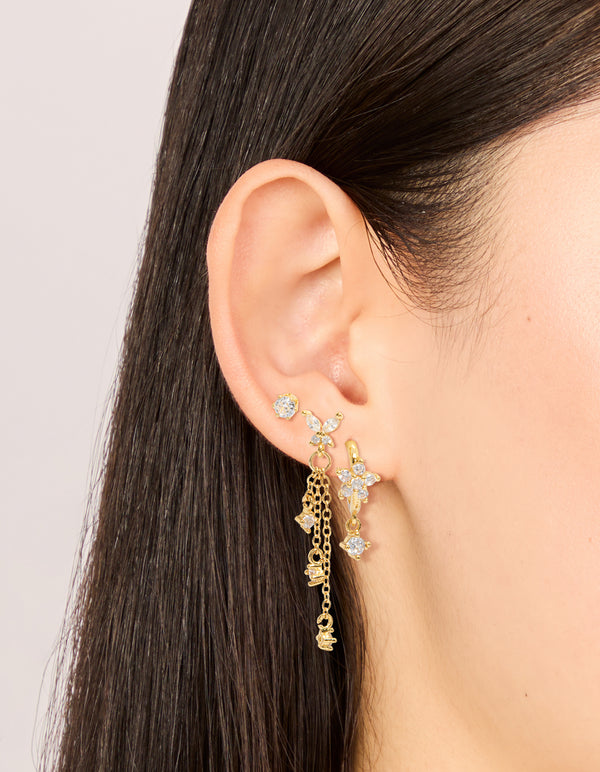Featuring gold plated cubic zirconia butterfly chain and stud earrings 3-pack with charm and huggie closure on ear view