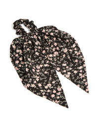 Crafted from floral printed fabric in black and pink accents, this statement scarf scrunchie is shown in front view - link has visual effect only