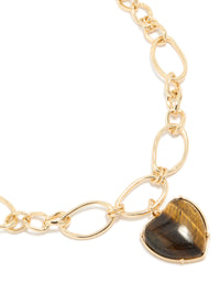 Showcasing a gold loop chain necklace with brown heart pendant close up view - link has visual effect only