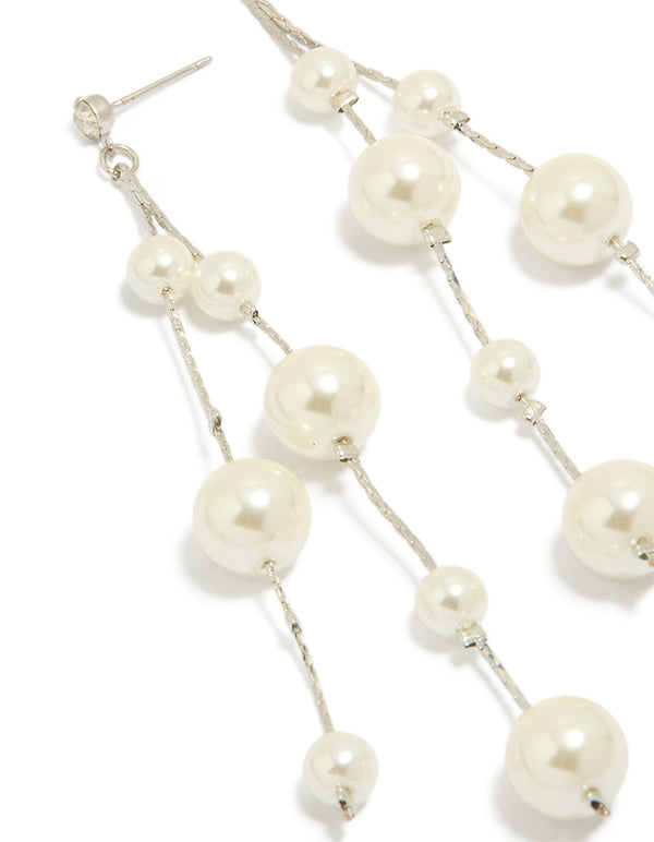 Elegant silver pearl drop earrings in white close up view