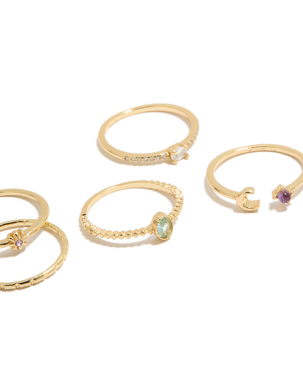Elegantly arranged five-piece celestial set showcasing moon and sun motifs in gold plated cubic zirconia oval cut dainty rings close up view