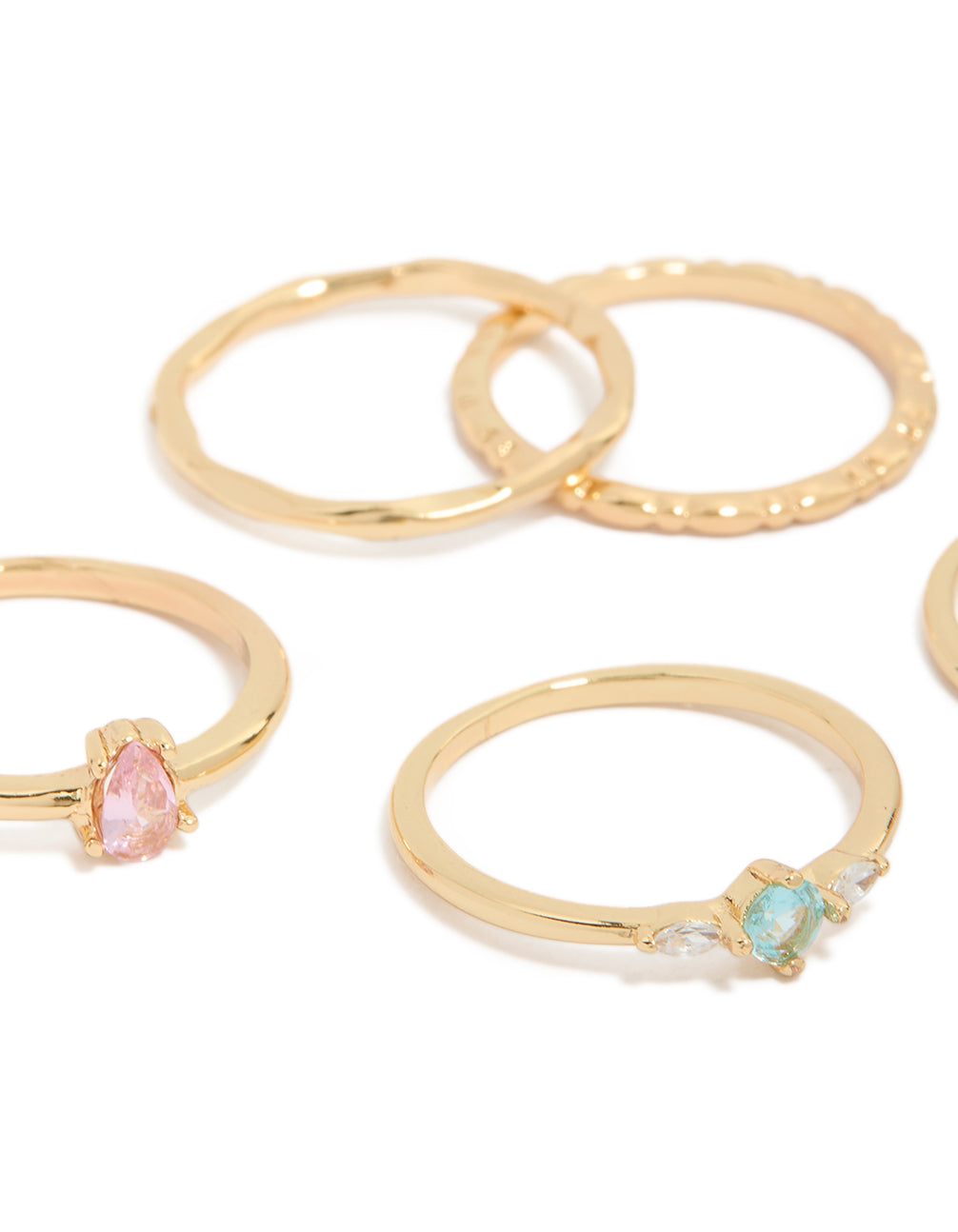 Highlighting crystal embellished rings in a set of five with detailed stone settings close up view