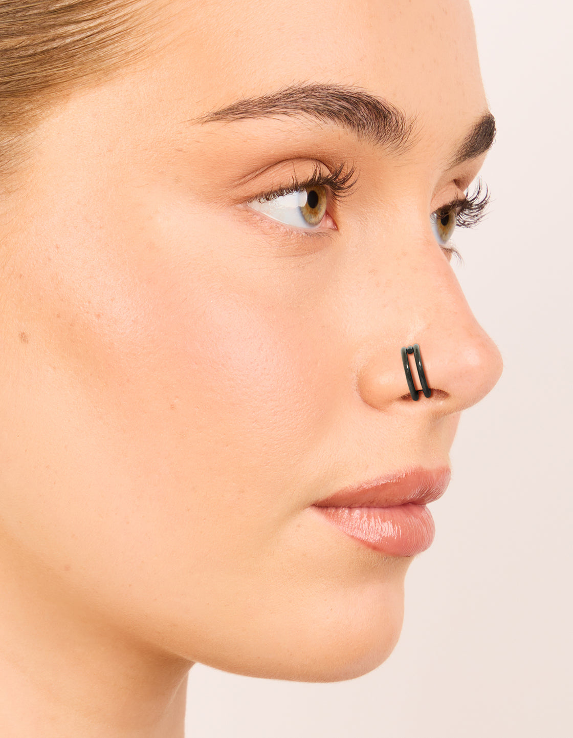 Featuring black coated surgical steel double hinged and plain nose rings pack in chunky style nose view