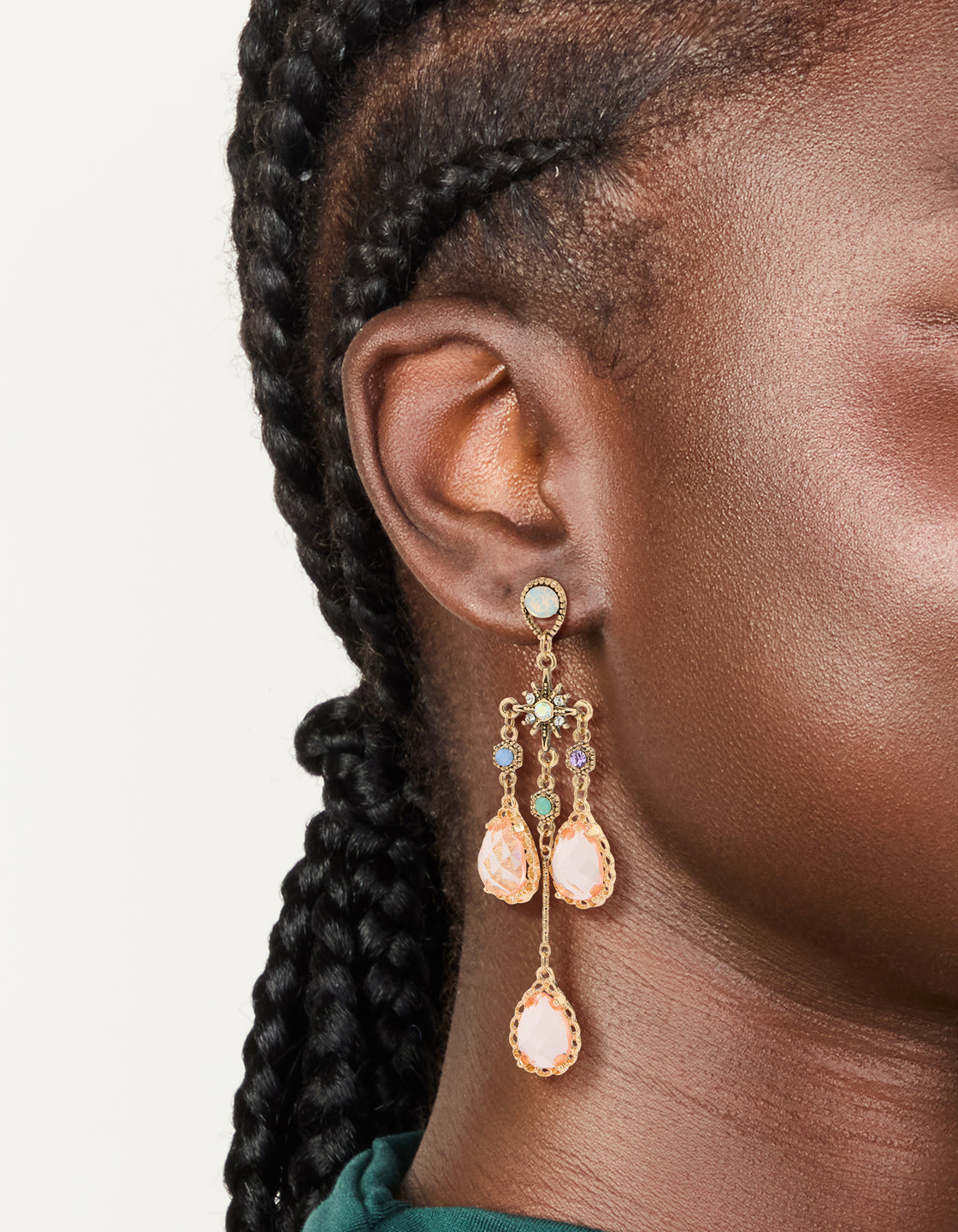 Featuring long drop earrings with celestial star charms and irregular pink teardrop diamantes , featuring stud closure, statement style on ear view