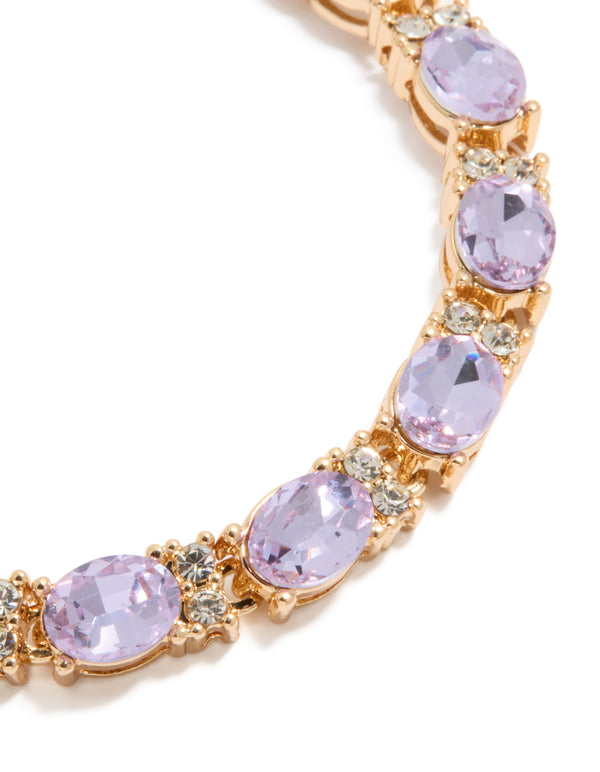 Featuring a gold statement bracelet with purple diamantes in a lavender and clear finish close up view