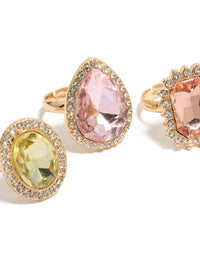Designed with statement halo and oval stone cut diamante rings in pink and purple pastel tones close up view - link has visual effect only
