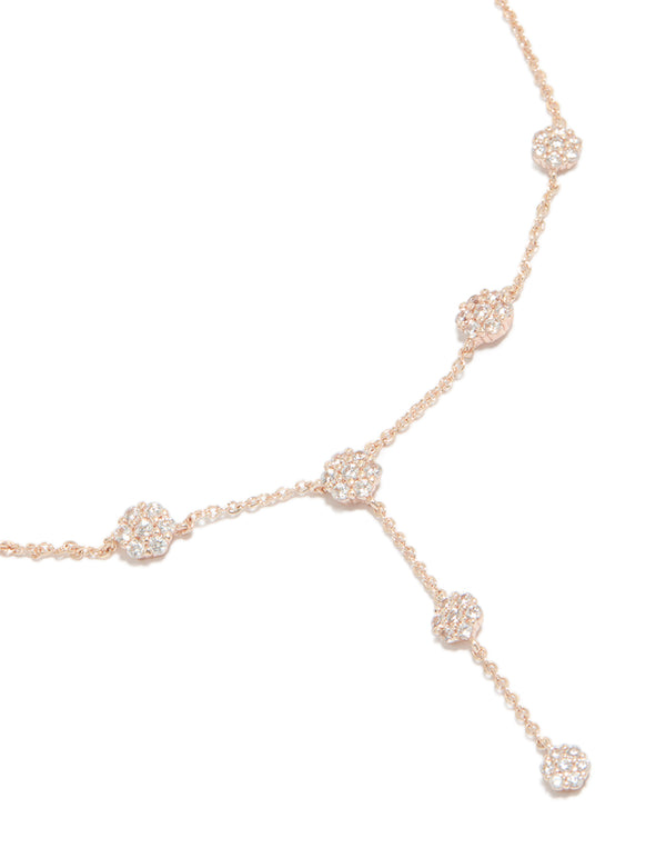 Showcasing a rose gold cubic zirconia mini floral y-necklace with charm featuring dainty pattern close up view