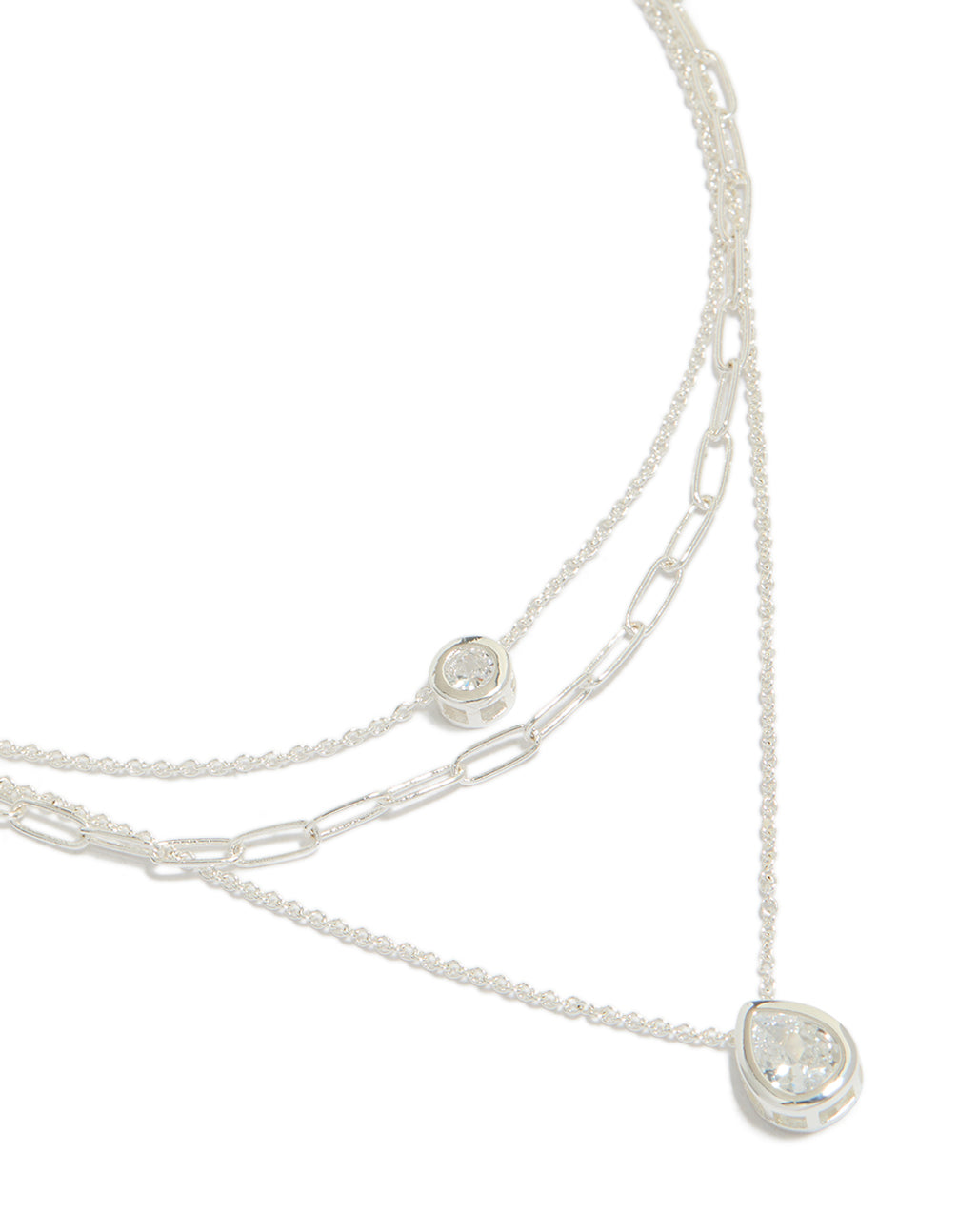 Crafted from silver plated material featuring cubic zirconia bezel chain layered necklace close up view