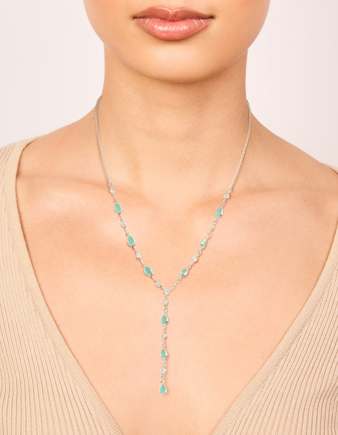 Elegant Y-necklace with plated metal and turquoise stones in an oval shape on neck view