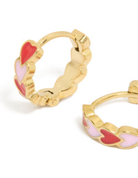 Featuring waterproof heart huggie earrings made from gold plated stainless steel with red and pink enamel in Huggie closure close up view - link has visual effect only