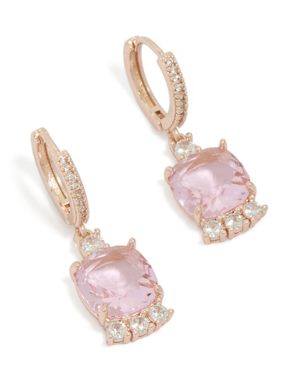 Presenting square statement huggie earrings crafted from rose gold plated material with pink cubic zirconia and crystal details front view