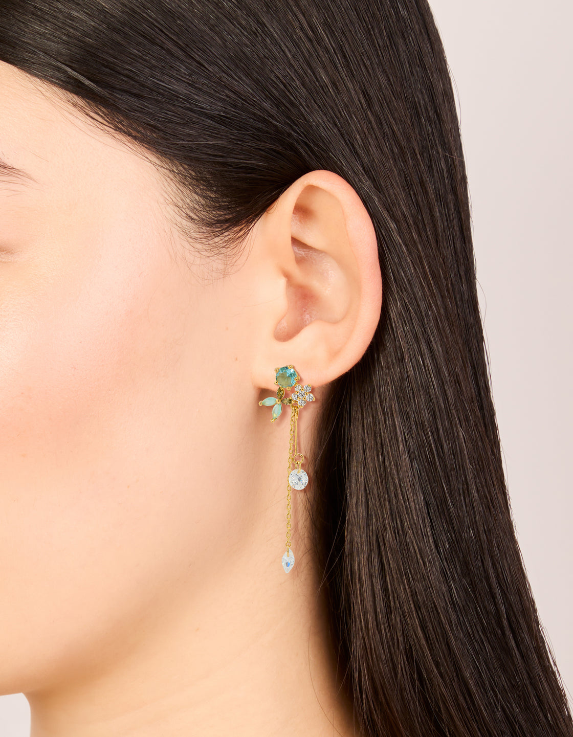 Elegant gold plated aqua blue cubic zirconia butterfly stud chain drop earrings featuring charm accents on ear view