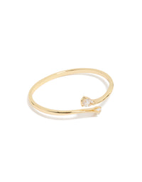 Crafted from gold plated material featuring cubic zirconia flat teardrop open front bangle in statement style front view - link has visual effect only