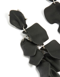 Beautifully crafted statement black coated metal petal drop earrings close up view - link has visual effect only