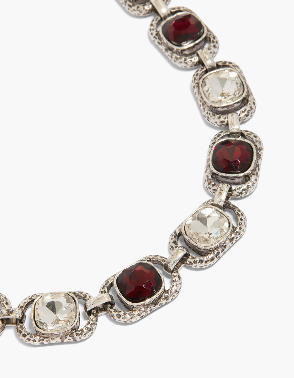 Beautifully crafted silver chunky necklace with clear and burgundy diamante stones close up view