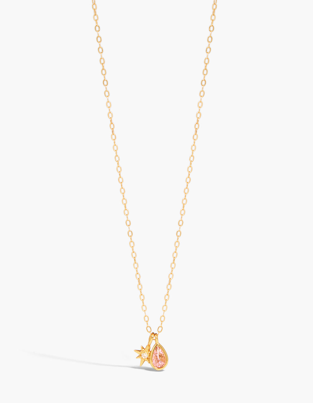 Showcasing a gold plated sterling silver pink cubic zirconia October birthstone necklace featuring celestial star charm and pendant in front view