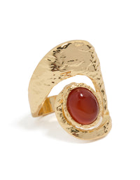 Introducing a statement gold plated molten large stone ring featuring a dark orange cabochon in textured metal front view - link has visual effect only