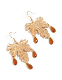 Showcasing statement drop earrings with floral leaf design featuring orange beads in gold front view - link has visual effect only