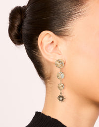 Elegant gold triple jewel drop earrings with celestial star charms on ear view - link has visual effect only