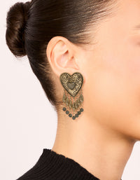 Featuring antique gold textured heart drop earrings with beads, and charm details in statement style on ear view - link has visual effect only