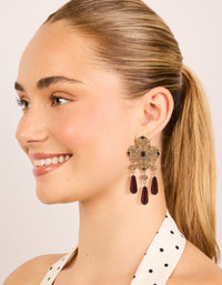 Crafted from gold with charm, and beads design statement drop earrings in maroon on model view - link has visual effect only