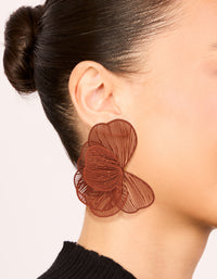 Featuring coated wire orange petal stud earrings with floral design in sienna on ear view - link has visual effect only