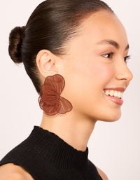 Crafted coated wire orange petal stud earrings with floral design in sienna on model view - link has visual effect only