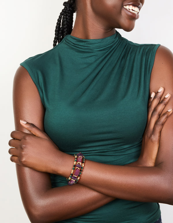 Featuring beads and balls in dark magenta, gold, green, and black, this chunky 3-pack of mixed stretch bracelets is shown on model view