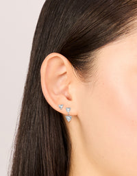 Featuring waterproof stainless steel cubic zirconia heart stud and drop earrings in a 2-pack with silver and clear tones on ear view - link has visual effect only