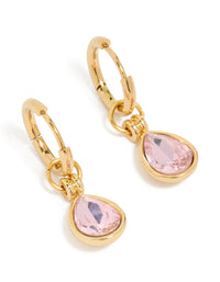 Showcasing waterproof huggie earrings with pink cubic zirconia in pear cut, crafted from gold plated stainless steel and crystal front view - link has visual effect only