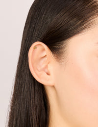 Discover dainty single gold plated titanium double flower stud with cubic zirconia and flat back closure on ear view - link has visual effect only