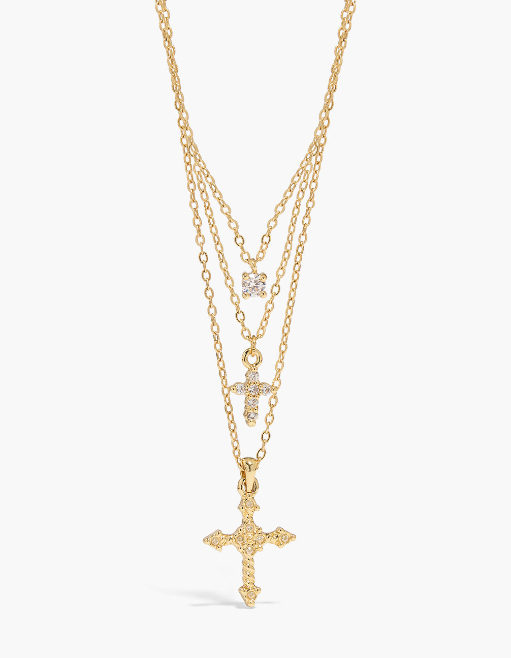 Showcasing a gold plated layered necklace with cross cubic zirconia and crystal details close up view