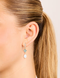 Elegant gold plated drop earrings featuring blue diamante with freshwater pearls on ear view - link has visual effect only