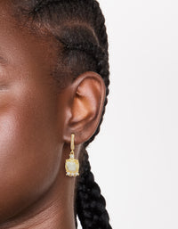 Elegant gold plated cubic zirconia yellow square drop huggie earrings with hoop closure in clear on ear view - link has visual effect only