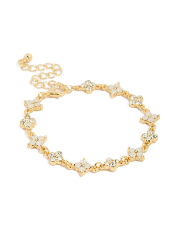Featuring a flower bracelet crafted from gold plated metal with cubic zirconia in beige and clear, statement style front view