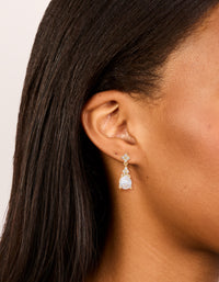 Elegant gold plated cubic zirconia flower teardrop earrings with floral design in clear on ear view - link has visual effect only