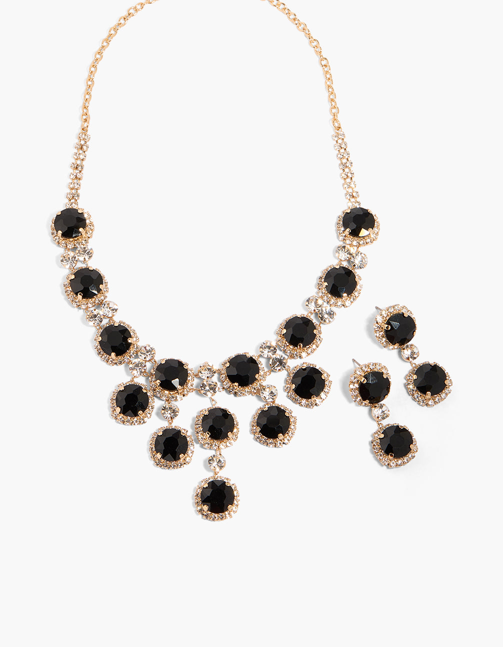 Showcasing a gold clear and black diamante circles necklace with earrings set close up view